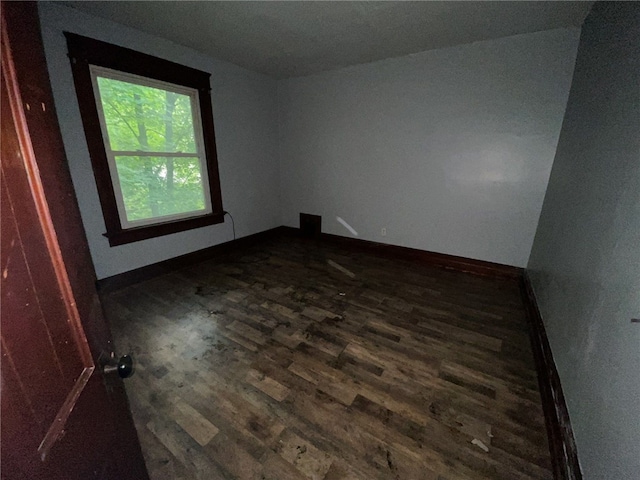 unfurnished room featuring dark hardwood / wood-style flooring