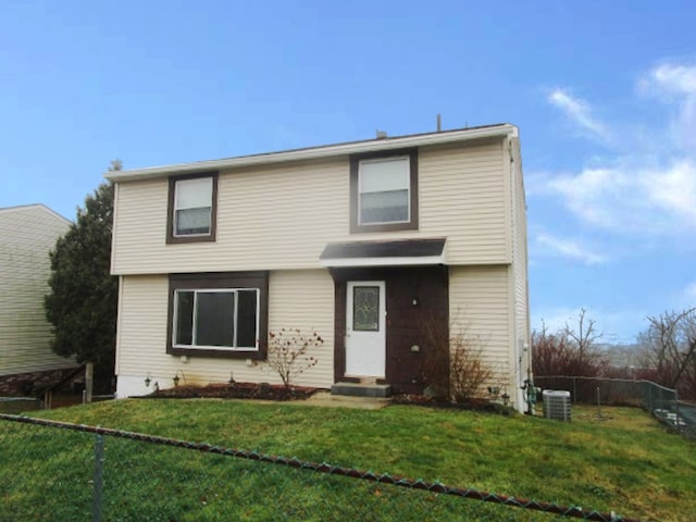 view of property featuring cooling unit and a front lawn