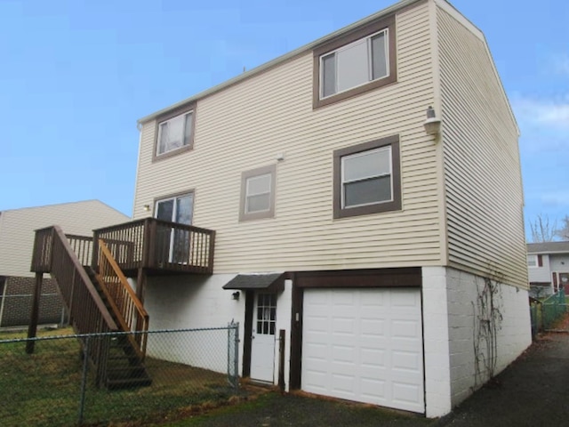 rear view of house featuring a garage