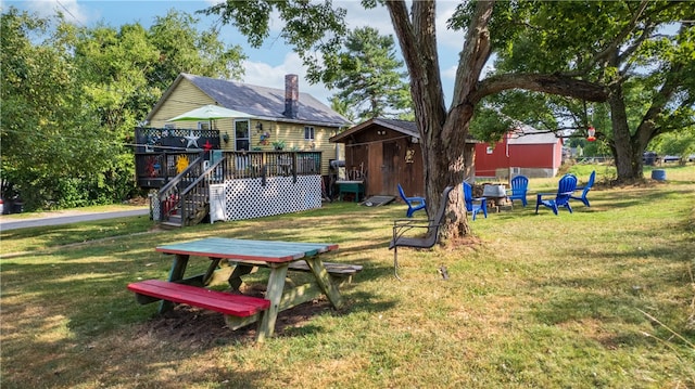 view of yard featuring a wooden deck and an outdoor fire pit