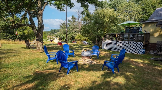 view of yard with a fire pit and a deck