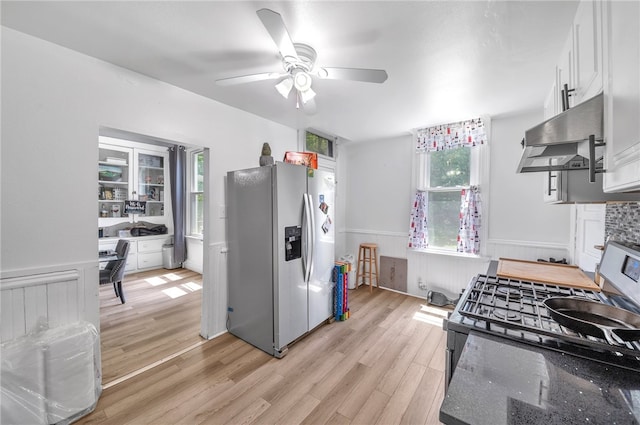 kitchen featuring range, white cabinets, light hardwood / wood-style flooring, stainless steel fridge, and ceiling fan