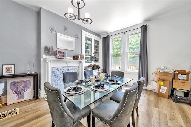 dining room with a notable chandelier and light hardwood / wood-style floors