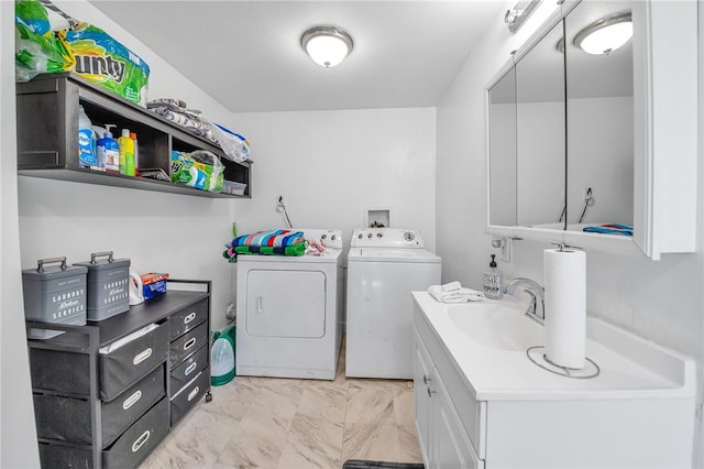 laundry area featuring light tile floors, washing machine and dryer, sink, and hookup for a washing machine