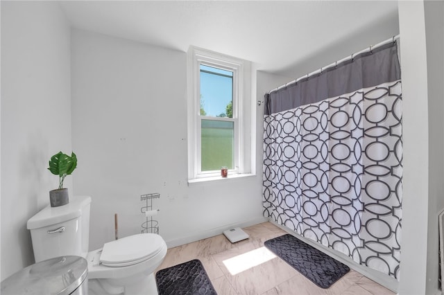 bathroom featuring toilet and tile floors