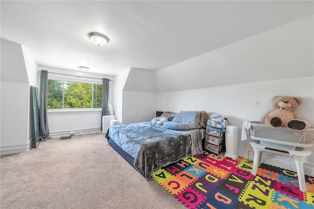 carpeted bedroom with lofted ceiling