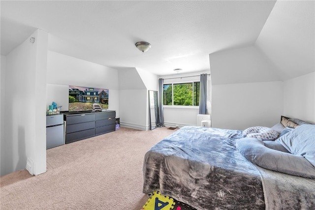 bedroom with lofted ceiling and light colored carpet