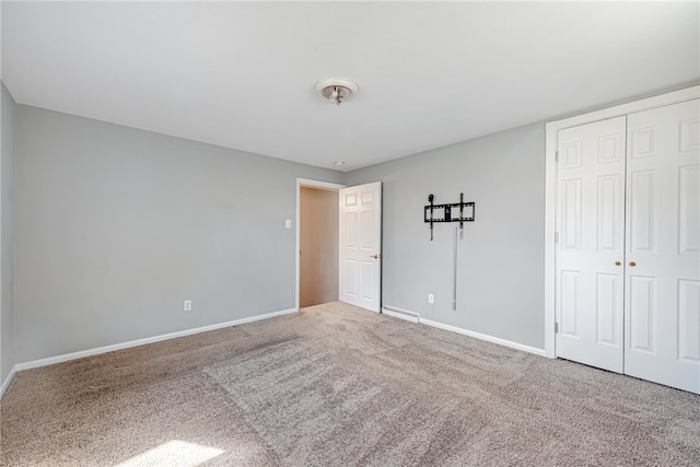 unfurnished bedroom featuring a closet and light colored carpet