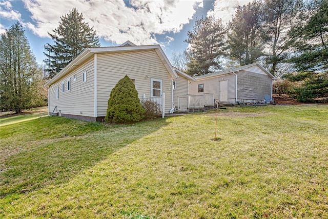 rear view of property featuring a lawn