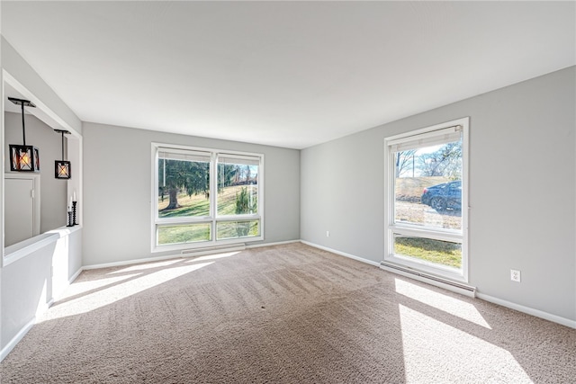 empty room featuring light carpet and a baseboard heating unit