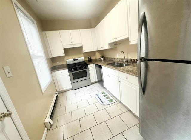 kitchen with white cabinetry, sink, appliances with stainless steel finishes, light tile patterned floors, and a baseboard heating unit