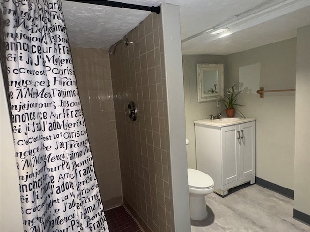 bathroom featuring walk in shower, vanity, toilet, and a textured ceiling