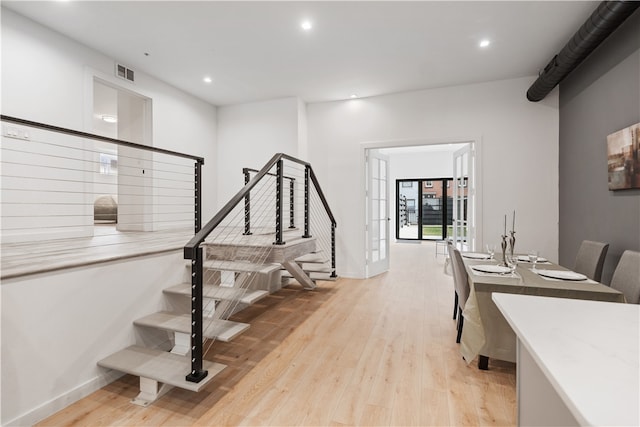 staircase with light hardwood / wood-style flooring