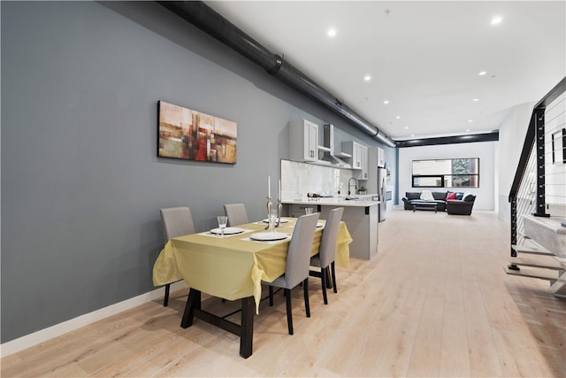 dining room featuring light hardwood / wood-style floors and sink