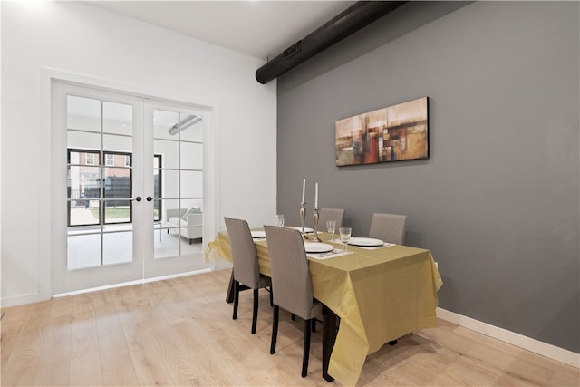 dining area with light hardwood / wood-style floors and french doors