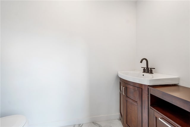 bathroom with tile flooring, toilet, and vanity