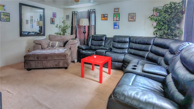 carpeted living room with ceiling fan