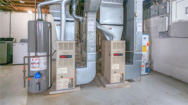 utility room featuring water heater and independent washer and dryer