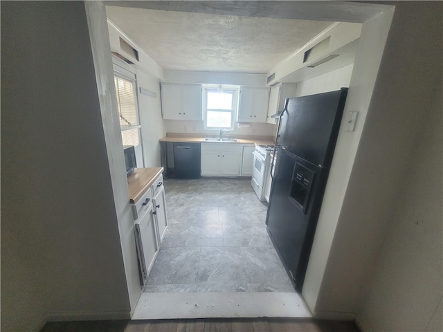 kitchen with butcher block counters, white cabinets, light tile floors, and black appliances