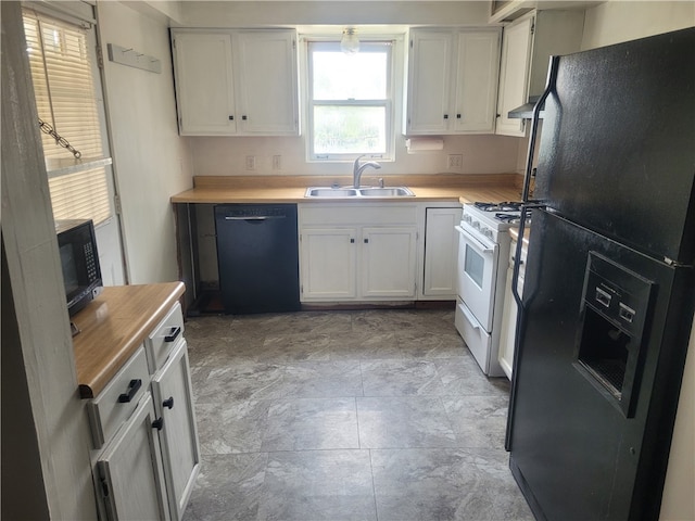 kitchen with sink, white cabinetry, black appliances, and light tile floors