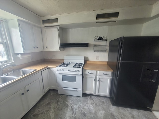 kitchen featuring light tile floors, white cabinetry, white gas range, and black fridge with ice dispenser