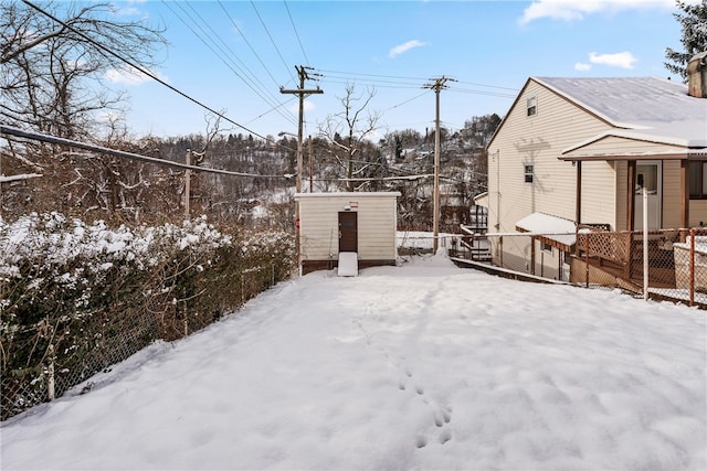 snow covered patio featuring an outdoor structure