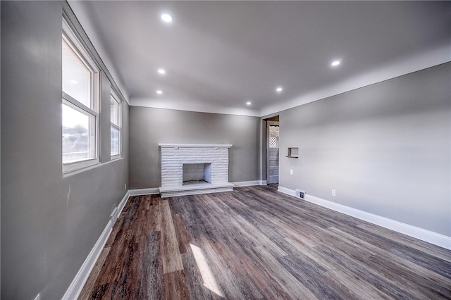 unfurnished living room featuring dark hardwood / wood-style flooring