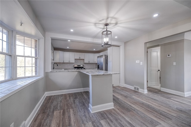 kitchen with hanging light fixtures, backsplash, dark hardwood / wood-style floors, a chandelier, and stainless steel refrigerator with ice dispenser