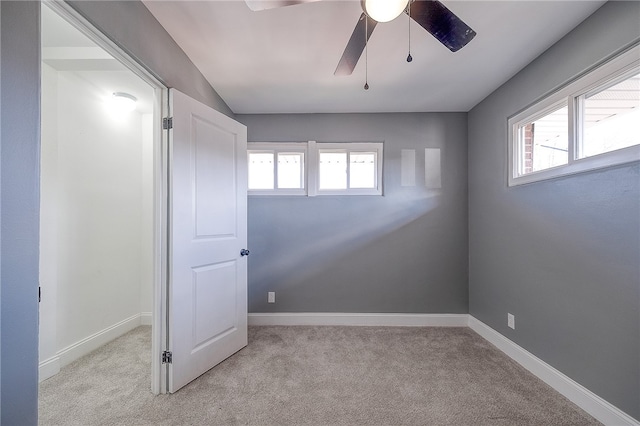 spare room with light carpet and ceiling fan