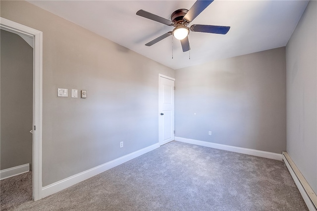 empty room featuring baseboard heating, dark carpet, and ceiling fan