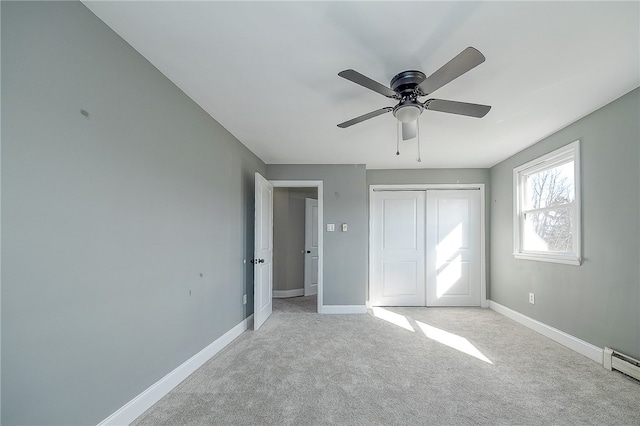 unfurnished bedroom with ceiling fan, light colored carpet, and a closet