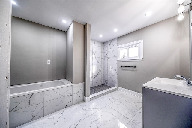 bathroom with vanity, a relaxing tiled bath, and tile flooring