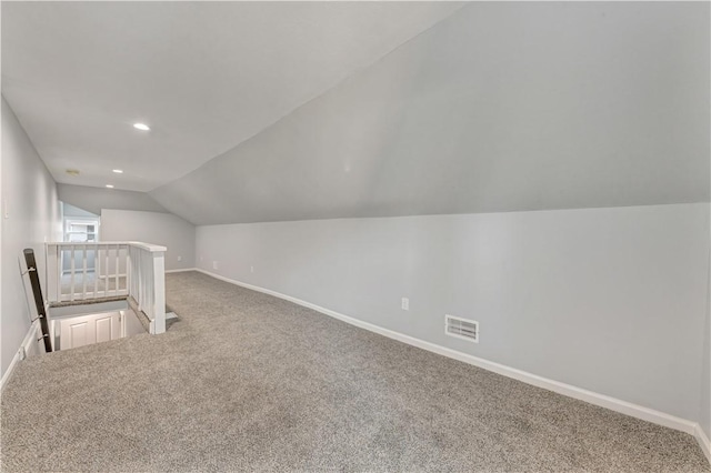 bonus room featuring carpet flooring and vaulted ceiling