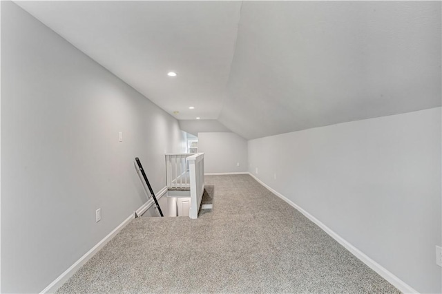 bonus room with carpet and vaulted ceiling