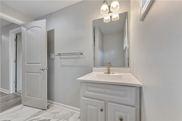 bathroom with a chandelier and vanity