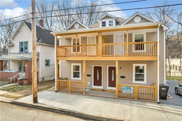 view of front of home featuring covered porch and a balcony