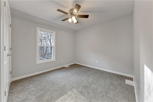 spare room with ceiling fan and carpet