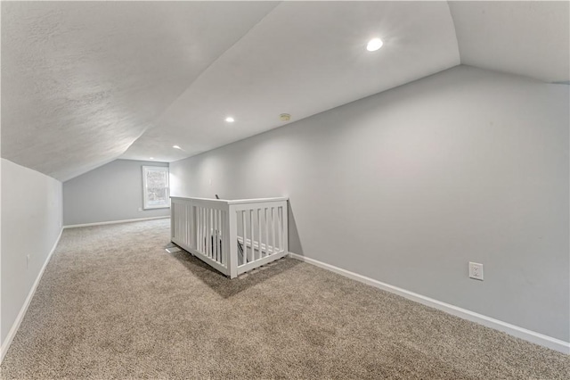 additional living space with carpet floors and lofted ceiling