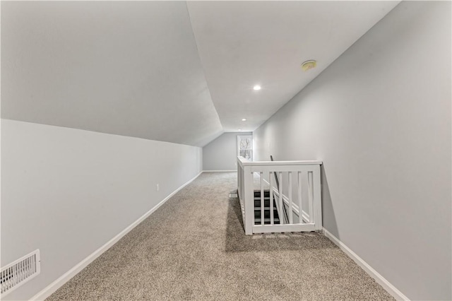 additional living space with carpet floors and vaulted ceiling