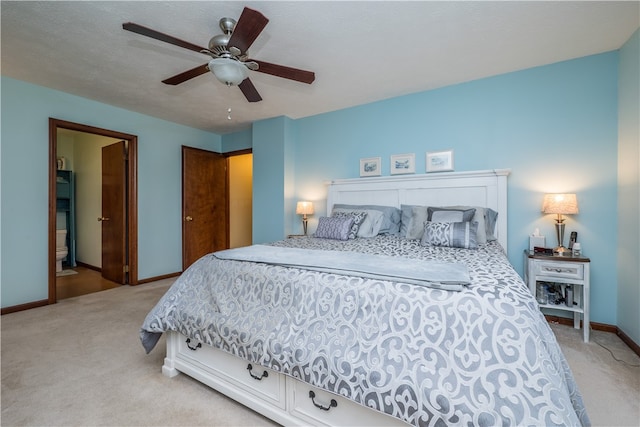 carpeted bedroom featuring ceiling fan and connected bathroom