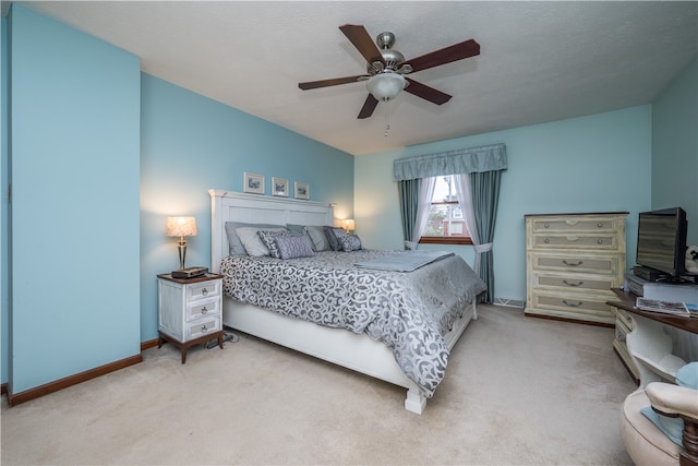 bedroom featuring light carpet and ceiling fan