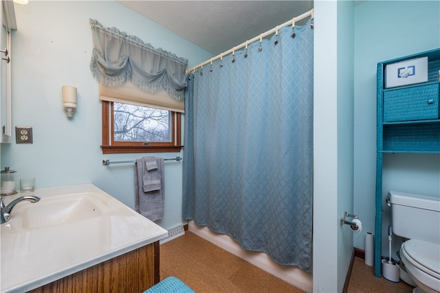 bathroom with toilet, a textured ceiling, and vanity