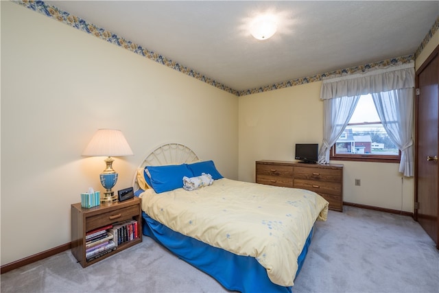 bedroom featuring light carpet