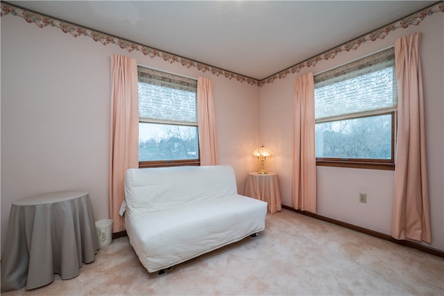 sitting room featuring light carpet and a healthy amount of sunlight