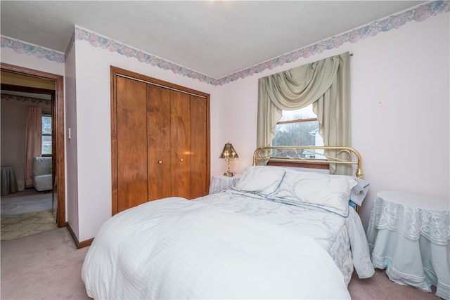 bedroom with light carpet and a closet