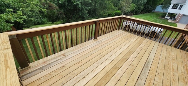 wooden terrace featuring a lawn