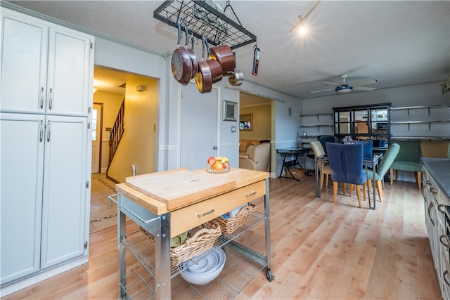 dining space featuring ceiling fan, light hardwood / wood-style floors, and a textured ceiling