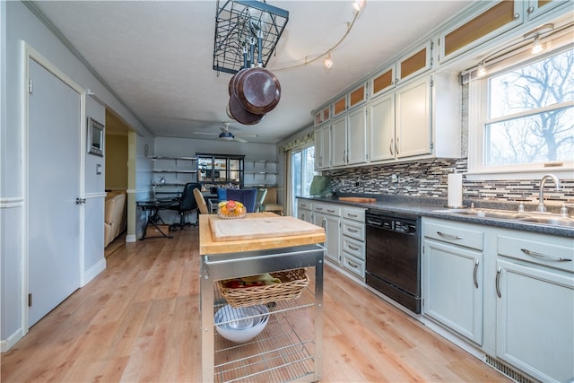 kitchen featuring tasteful backsplash, black dishwasher, white cabinetry, light wood-type flooring, and ceiling fan