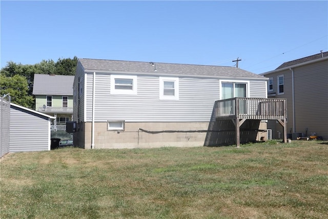 back of house with a yard and a wooden deck