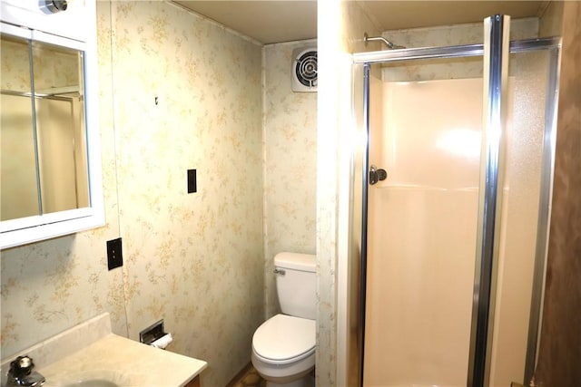 bathroom with toilet, walk in shower, and vanity